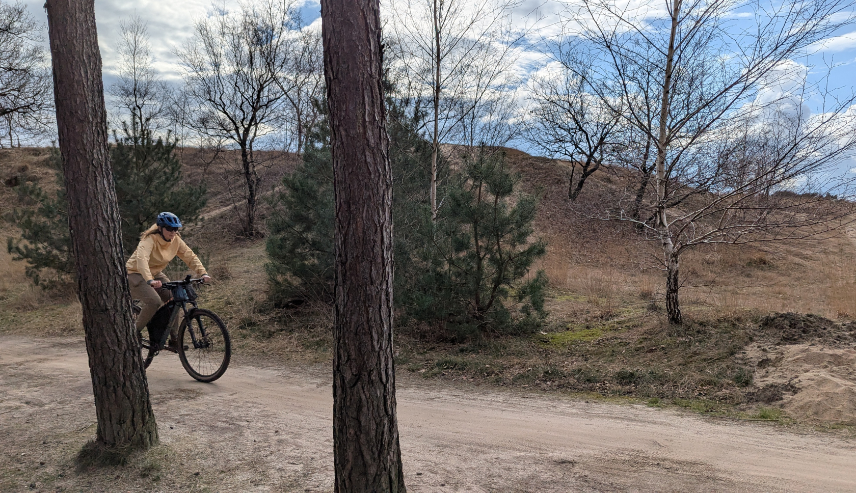 Een vrouw fietst door een natuurgebied