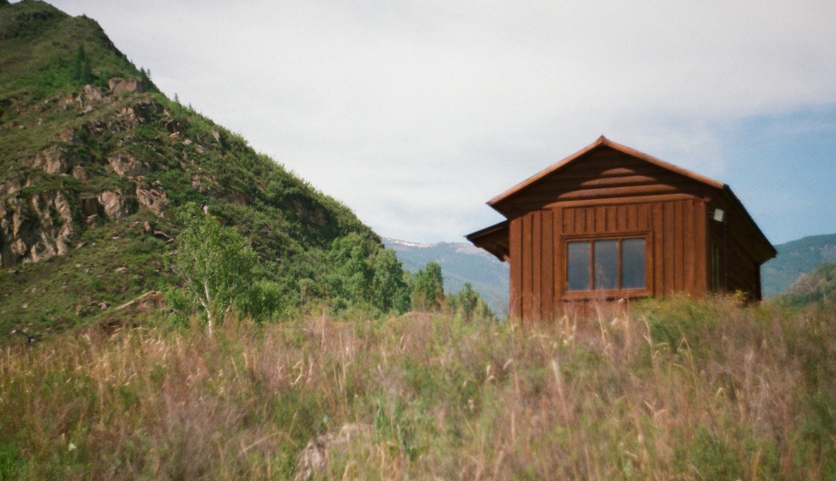 Twee personen staan in regenkleding op een bergtop.