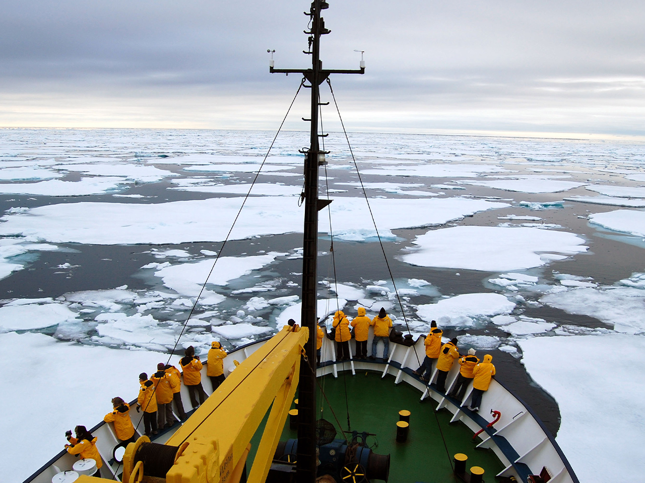 Sawadee - group of people standing on the bow of a ship surrounded by ice flows
